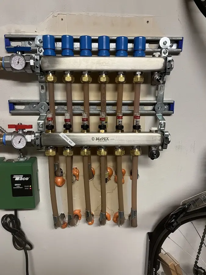 Plumber performing Water Heater Repair at a residential property in Hales Corners